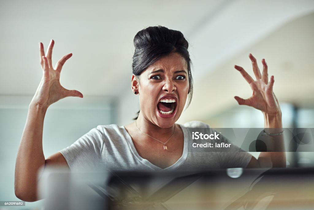 I've had enough! Shot of a frazzled young businesswoman having an outburst in the office Women Stock Photo