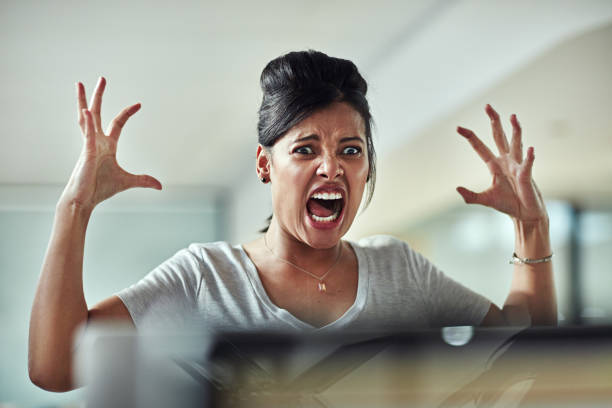 I've had enough! Shot of a frazzled young businesswoman having an outburst in the office screaming stock pictures, royalty-free photos & images