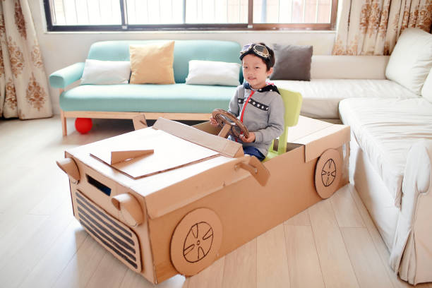 istock Children play in the cardboard car 642100300