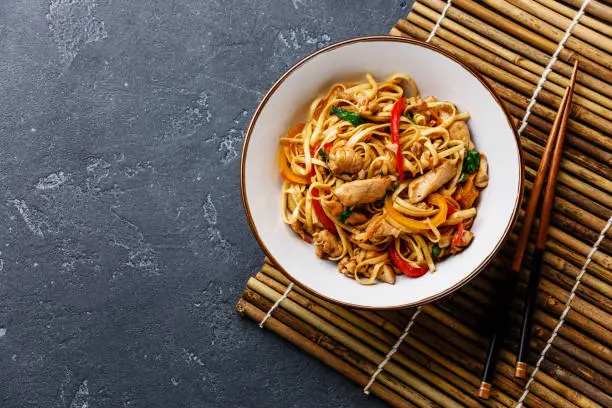 Photo of Udon stir-fry noodles with chicken in bowl