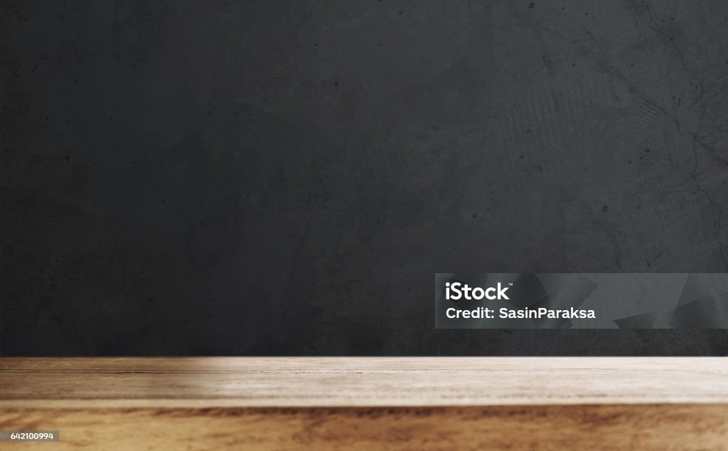 Wooden table top with defocus black wall background Wooden table top with blurred defocus black wall background Wood - Material Stock Photo