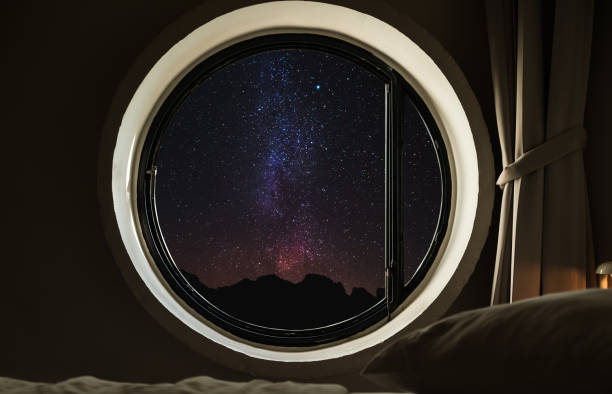 istock Round circle window frame with night sky full of stars with milky way 642103600