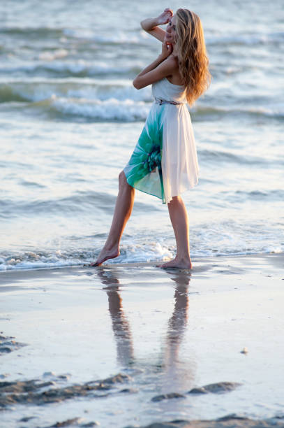 istock Woman walking on the beach 642120888