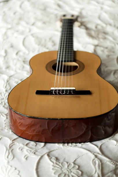 istock Spanish guitar lying on the bed 642124472