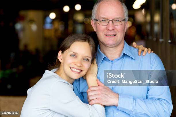 Happy Adult Daughter Embracing Middleaged Father Stock Photo - Download Image Now - Mature Adult, Niece, Uncle