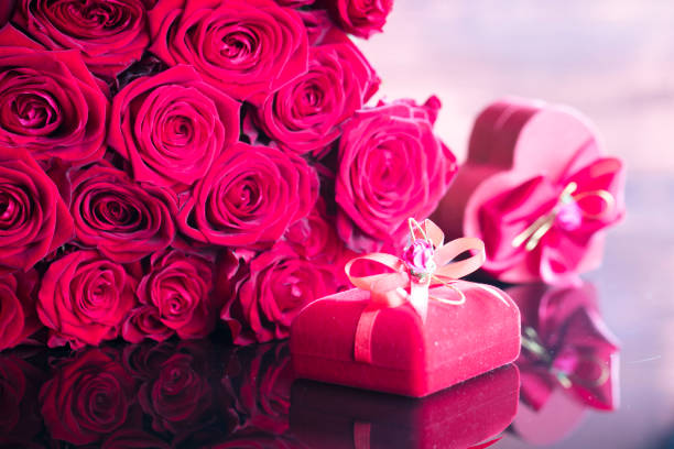 Roses and gifts on glass table