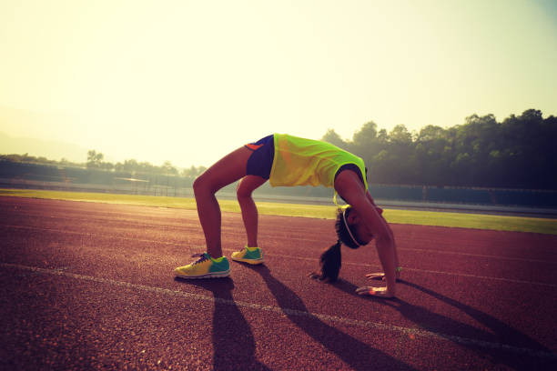 istock young asian woman backbending on stadium track 642166366