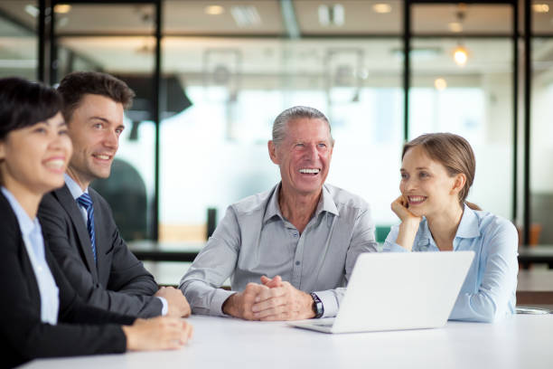 istock Cheerful businesspeople sitting in boardroom 642173042