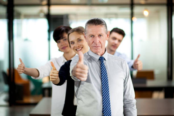 istock Successful team and senior leader showing thumb up 642173170