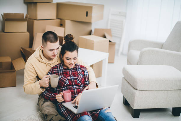 istock Couple on floor next to moving boxes 642173400