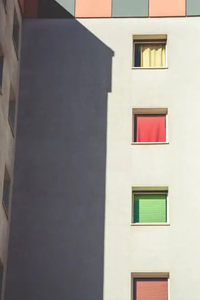 residential building with colorful curtains at the windows