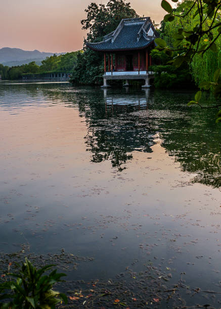 China, Hangzhou. Paradise in heaven and on earth - Hangzhou and Suzhou - Chinese proverb . Sunset at West Lake (Xihu)- Hangzhou main attractions .