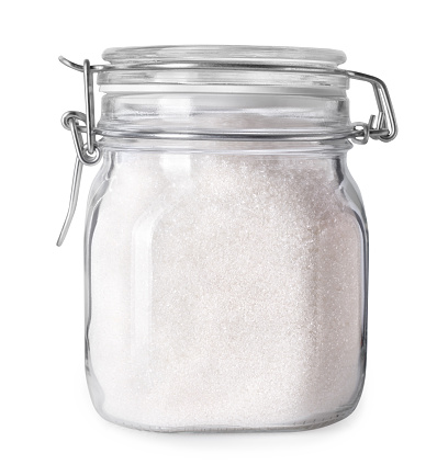 Granulated sugar in glass jar container isolated on white background with clipping path