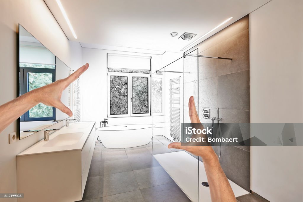 Planned renovation of a Luxury modern bathroom Planned renovation of a Luxury modern bathroom, Bathtub in corian, Faucet and shower in tiled bathroom with windows towards garden Bathroom Stock Photo