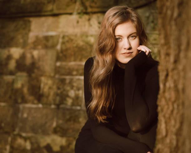 istock Beautiful young woman in black 642236160
