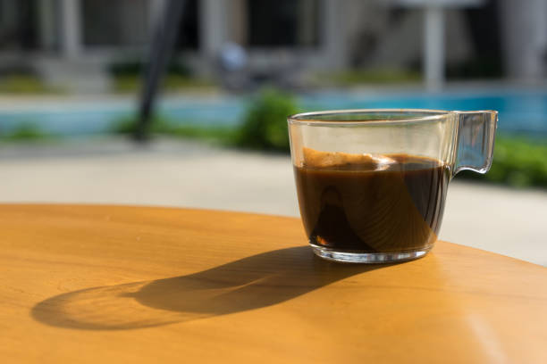 istock a cup of coffee on wood table with blur background. 642236202