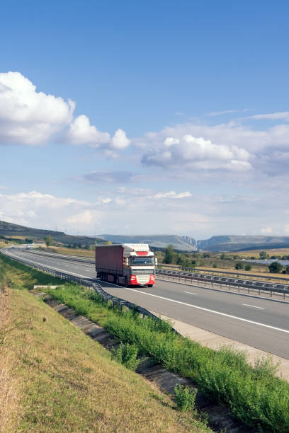 istock Red truck on highway 642236272