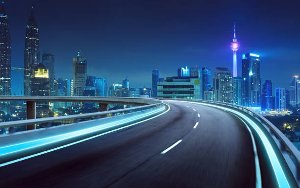 istock Highway overpass motion blur with city background . night scene . 642236392