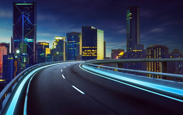 istock Highway overpass motion blur with city background . night scene . 642236400