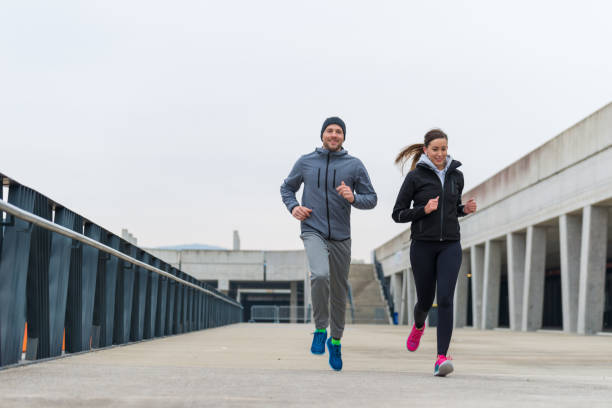 istock Young couple running together 642239048