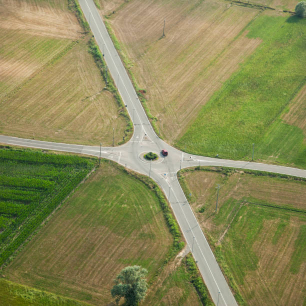 istock Red car on a cross road in countryside 642241872