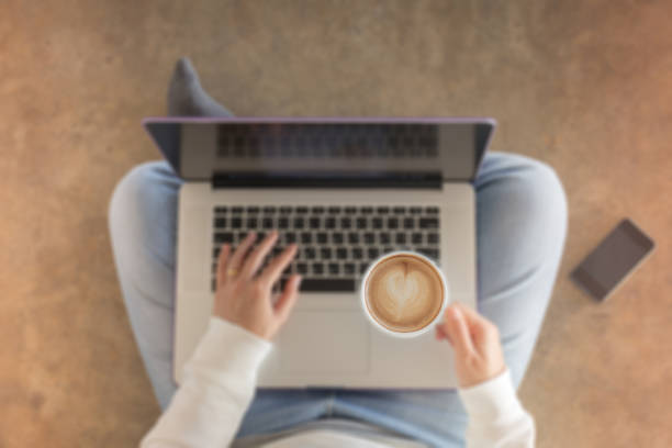 istock Woman sitting on floor with laptop 642242292