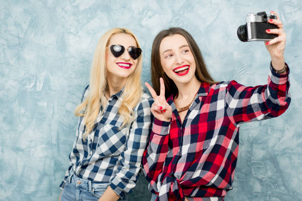 istock Female friends on the blue wall background 642246526