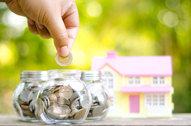 istock Savings money coins for house with sunlight 642246970