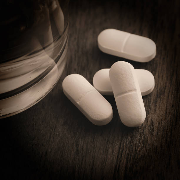 istock Tablets and a glass of water 642250898