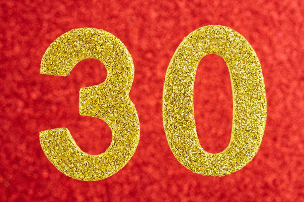 istock Number thirty yellow color over a red background. Anniversary. 642254710