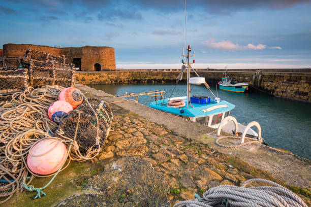 Beadnell Harbour Fishing Gear Beadnell is a village on the Northumberland coastline, with a small fishing harbour set into Beadnell Bay.  Disused medieval Lime Kilns sit in the harbour lime kiln lighthouse stock pictures, royalty-free photos & images