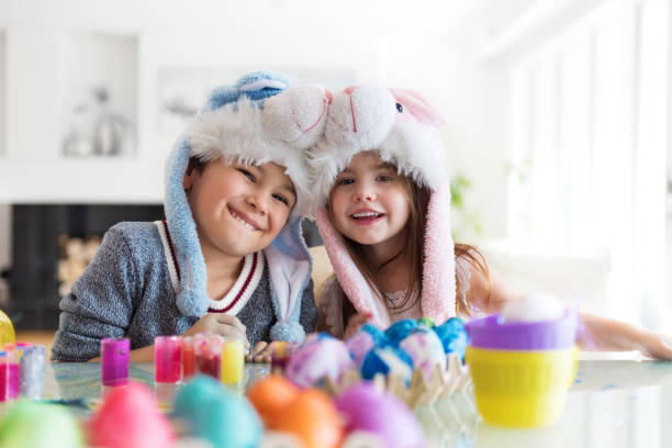 istock Boy and Girl painting Easter Eggs 642262198