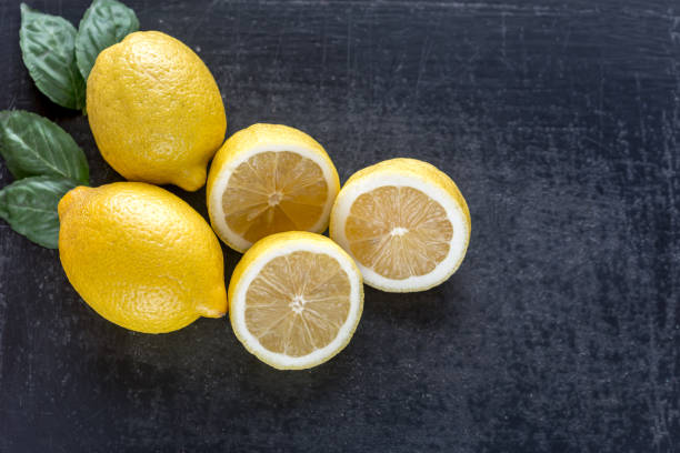 istock Fresh lemons on the dark wooden background 642262852