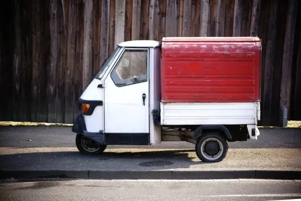 A three-wheel car or van with flat tires.