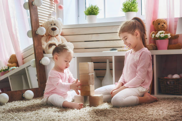 istock Funny lovely sisters 642276380