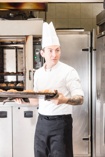 istock Pastry chef with baked croissant 642279602