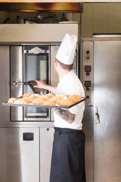 istock Pastry chef with baked croissant 642279730