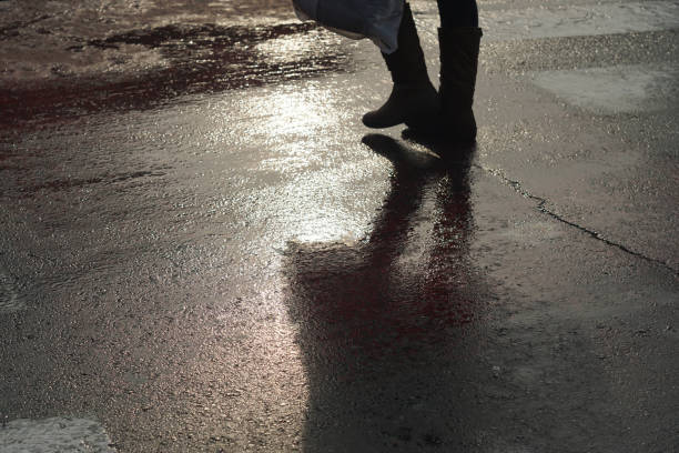 istock Shadow of unrecognizable person at pedestrian crossing - Back light 642285530