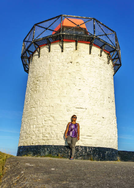 Outdoor lifestyle shoot of hispanic senior woman at lighthouse