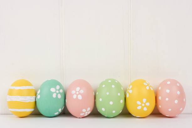 istock Row of Easter eggs over white wood 642295386