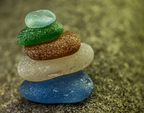 Stack of Five Sea Glass Pebbles in the Sand