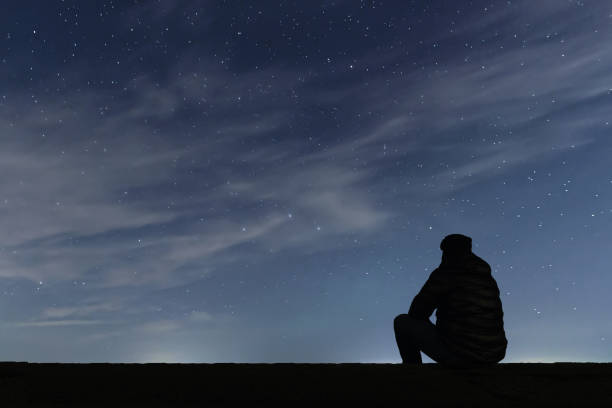 istock Man looking at the stars 642295718