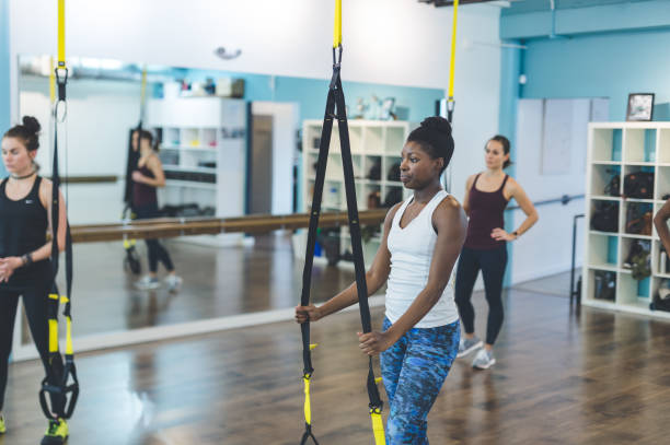 istock Group of Women Doing Barre + TRX Workout 642298980