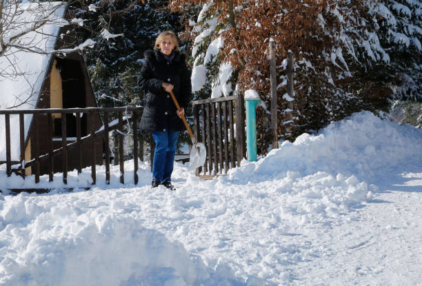 istock Senior woman Shoveling Snow 642299070