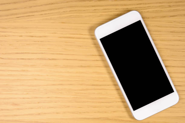 istock Smartphone on wood with space on screen for your text or image 642299248