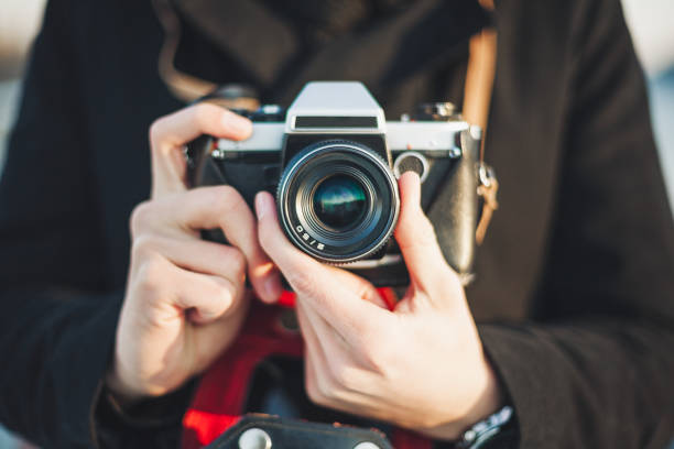 istock Hipster photographer taking photo with retro camera 642301698