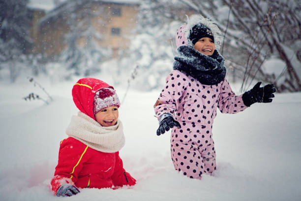 istock Two girls are playing in the snow 642302342