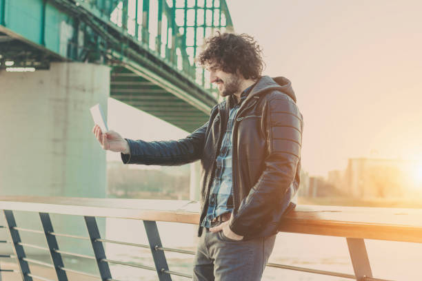 istock Handsome man using tablet in a center of city 642317252