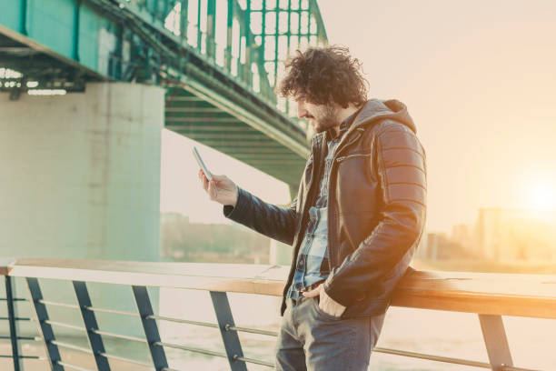 istock Handsome man using tablet in a center of city 642317300