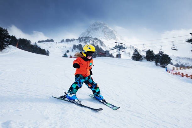 Little skier racing in snow Child skiing in mountains. Ski race for young children.  Andorra andorra photos stock pictures, royalty-free photos & images